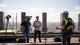 Interview bovenop Jubi toren Twee videomakers van Pro Motion Film interviewen inspecteur op dak van de Jubi Torens in Den Haag